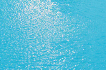 Blue water with ripples on the surface. Defocus blurred transparent blue colored clear calm water...