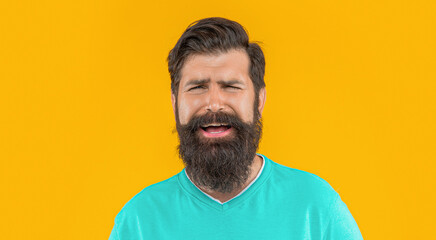 Obraz premium portrait of sad bearded guy isolated on yellow. portrait of bearded guy in studio.