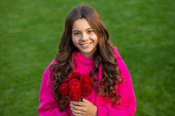 teenager girl with red fall flowers outdoor. teenager girl with fall flowers bouquet