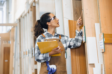 staff working in wood furniture industry factory checking selecting plywood wooden board type...