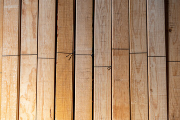 Wooden boards stored, wood timber construction material for background and texture. Stack of wooden bars