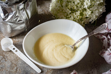 Semolina porridge in a white plate for small children. Close-up