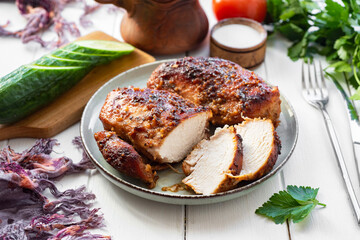Lunch for the whole family: chicken breast baked in mustard sauce on a plate. Close-up. Slices of chicken breast on a plate.