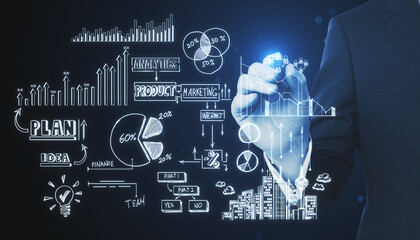 Close up of businessman hand pointing at creative toned business sketch on dark background. Business strategy and finance concept.