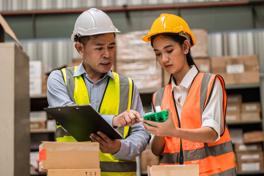 senior engineer manager supervisor working training young woman engineer staff worker in factory hardware parts store inventory room