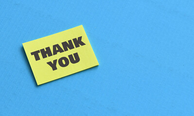 Thank You text on a yellow sheet of paper. Business Concept