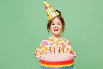 Little happy child kid girl 6-7 years old wear casual clothes birthday hat cone have fun hold cake...