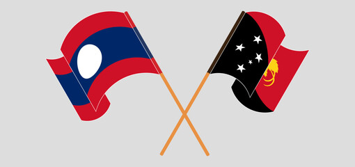Crossed and waving flags of Laos and Papua New Guinea