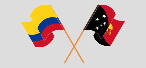 Crossed and waving flags of Colombia and Papua New Guinea