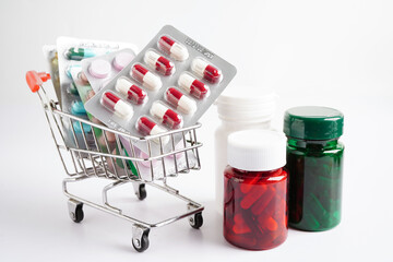 Shopping trolley with blister pill and capsule from drug prescription, pharmacy for treatment...