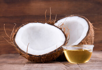 coconut with coconut oil on wooden baclground