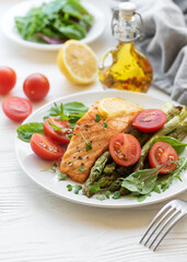 Baked Delicious salmon, green asparagus on  plate