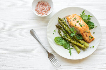 Baked Delicious salmon, green asparagus on  plate