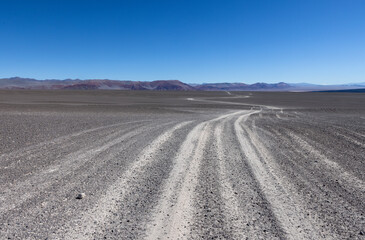 Fototapeta na wymiar Puna - off road adventure through a bizarre but beautiful landscape with a field of pumice, volcanic rocks and dunes of sand in the north of Argentina