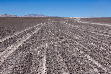 Fototapeta na wymiar Puna - off road adventure through a bizarre but beautiful landscape with a field of pumice, volcanic rocks and dunes of sand in the north of Argentina