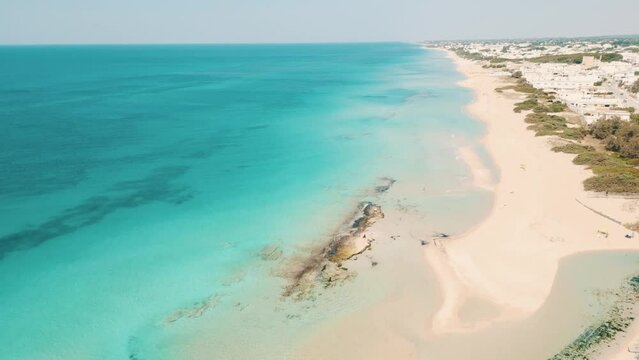 Salento, vista aerea della spiaggia di san pietro in bevagna e il mare blu cristallino in estate - Manduria, Taranto, Puglia, Italy