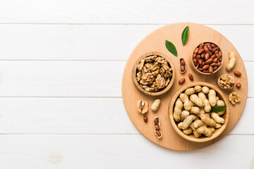 Walnut kernel halves, in a wooden bowl. Close-up, from above on colored background. Healthy eating Walnut concept. Super foods with copy space