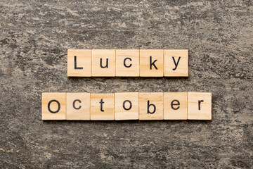 lucky october word written on wood block. lucky october text on table, concept