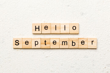hello september word written on wood block. hello september text on table, concept