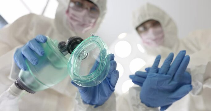 Doctors in protective suits and masks performing indirect heart massage and artificial respiration bottom view 4k movie. Emergency resuscitation care for patients during covid19 pandemic concept