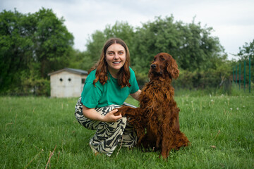 Caucasian woman hugging Irish Setter dog pet cute adorable red dog friendly closeup closing eyes...