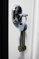 Home Ownership the day you get your new Keys to your new home. House keys inside door lock