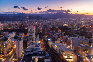 sunset or sun rise of Sapporo cityscape with Skyline and office building and downtown of sappiro is  populars ciy from toursim Hokkaido, Japan with twilight sky in spring season - obrazy, fototapety, plakaty