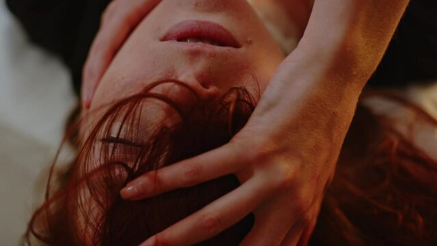 Beautiful ginger girl looking at camera with a moaning and lustful expression