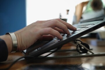 men's hand is typing on computer keyboard, vintage tone