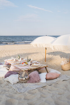 Luxuary setup picnic in Boho style on a beach, park. Bachelorette party, birthday celebration outdoors, wedding.  