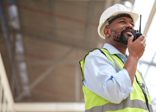 Walkie talkie, black man and engineer planning, communication and construction. African architect, radio and happy contractor with industrial project, building maintenance and engineering discussion.