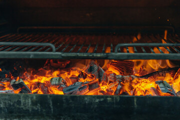 Heated hot charcoal grill and grill ready for BBQ. Close-up of burning coal. Smoldering coals on a...