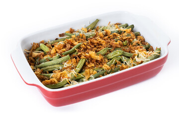 A traditional green bean casserole topped with French Fried Onions and cream of mushroom isolated...