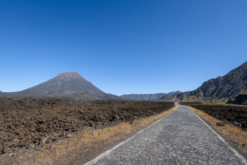 Pico do Fogo (2829m) rising from the caldera, old lava fields with new road