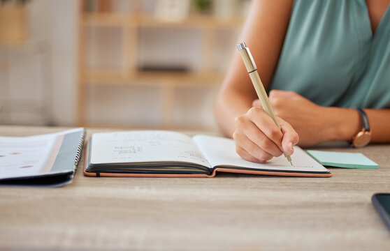 Hand, pen and writing in a notebook with a business woman sitting at a desk in her office for planning. Agenda, schedule and appointment with a female employee making a note in her journal or diary - Powered by Adobe