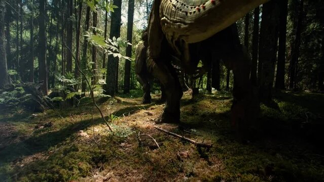 prehistoric T rex dinosaurs walking through the woods