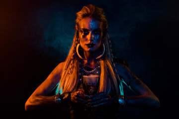 Portrait of fantasy valkyrie woman make demonic ritual hold potion cup orange lights isolated on black background