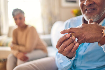 Senior man, hands and ring in divorce, fight or conflict from disagreement or argument on sofa at home. Elderly couple in depression, infertility or cheating, mistake and toxic marriage in the house