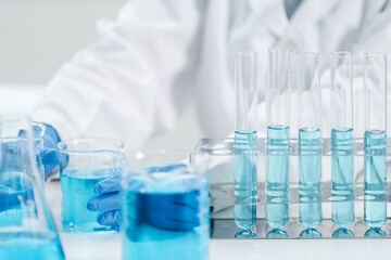 medicine research in chemical laboratory, chemist scientist working with liquid experiment test analysis by using scientific tube beaker glassware, chemistry science pharmaceutical medical lab concept