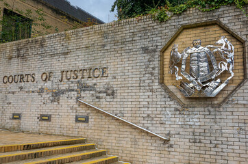 Courts of Justice entrance sign in UK city. Law ruling crown court 