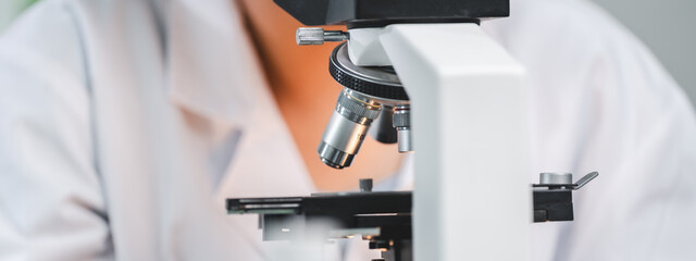 microscope tool technology using in laboratory, scientific equipment for microbiology science research, medicals scientist analysing experiment in term of biology or biotechnology for medicine test