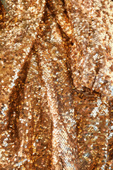 Waves of brightly shiny fabric with gold sequins