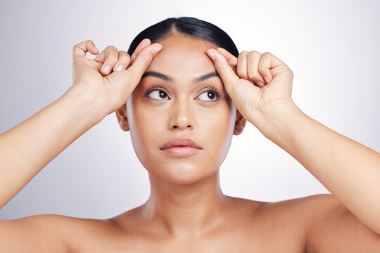 Face, Beauty And Eyebrows With A Model Woman In Studio On A Gray Background For Skincare Or Cosmetics. Facial, Makeup And Eyes With A Young Female Person Touching Her Skin After Facelift Treatment