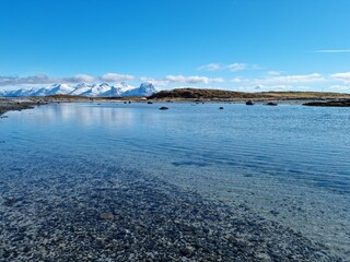 majestic landscape with the famous seven sisters mountain range in the background on a clear summer day in nordland, taken from the Herøy island