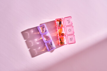 Bright pill box with different pills and vitamins.
