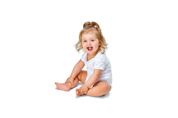 Happy, smiling child. Little baby girl, toddler sitting on floor and cheerfully laughing against...