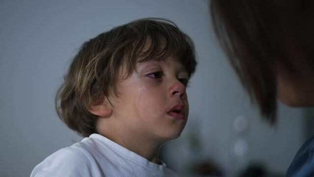 Sobbing child listening to mother scold him for misbehaving. Childhood education concept. Parent explaining son misbehavior. Tearful sad kid. Lifestyle real life
