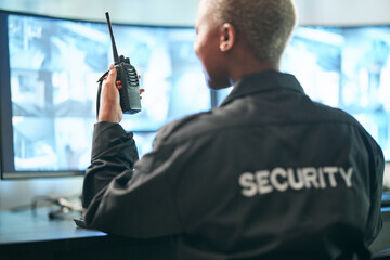 Back, security and radio surveillance with a woman officer in a control to monitor criminal...