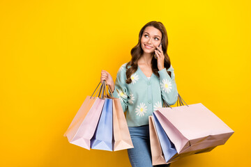 Photo of young influencer fashionista blogger lady call smartphone commerce proposition look empty space bargains isolated on yellow color background