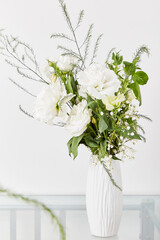 Aesthetic white pastel bouquet of eustoma, rose, gypsophila. Biophilic interior, cozy home